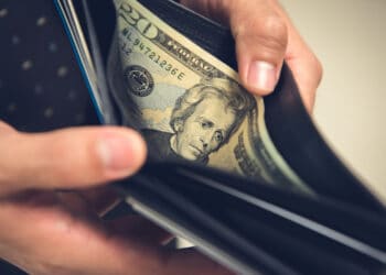 A man opening wallet looking for some money