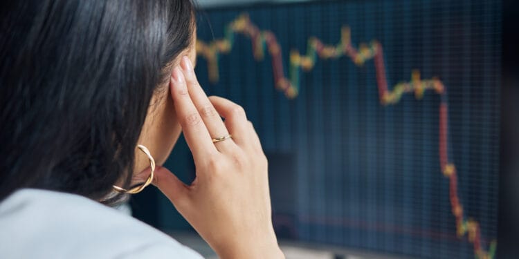 Shot of an unrecognisable businesswoman sitting in her office at night and feeling stressed while using her computer