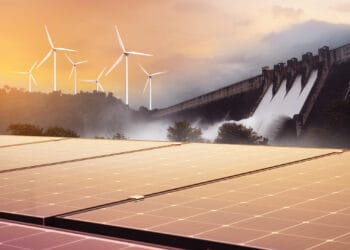 Electricity from solar panels, dams, and wind turbines. Environmentally-friendly renewable energy concept.