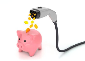 Coins fall into the piggy bank from the plug for charging electric car. Economy fuel concept. isolated on white background